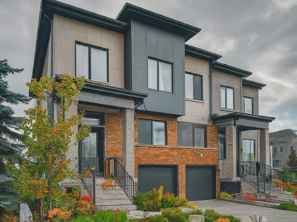 Investing in Stittsville Real Estate. Stittsville street scene showcasing typical semi-detached homes with mature trees, sidewalks, and driveways.